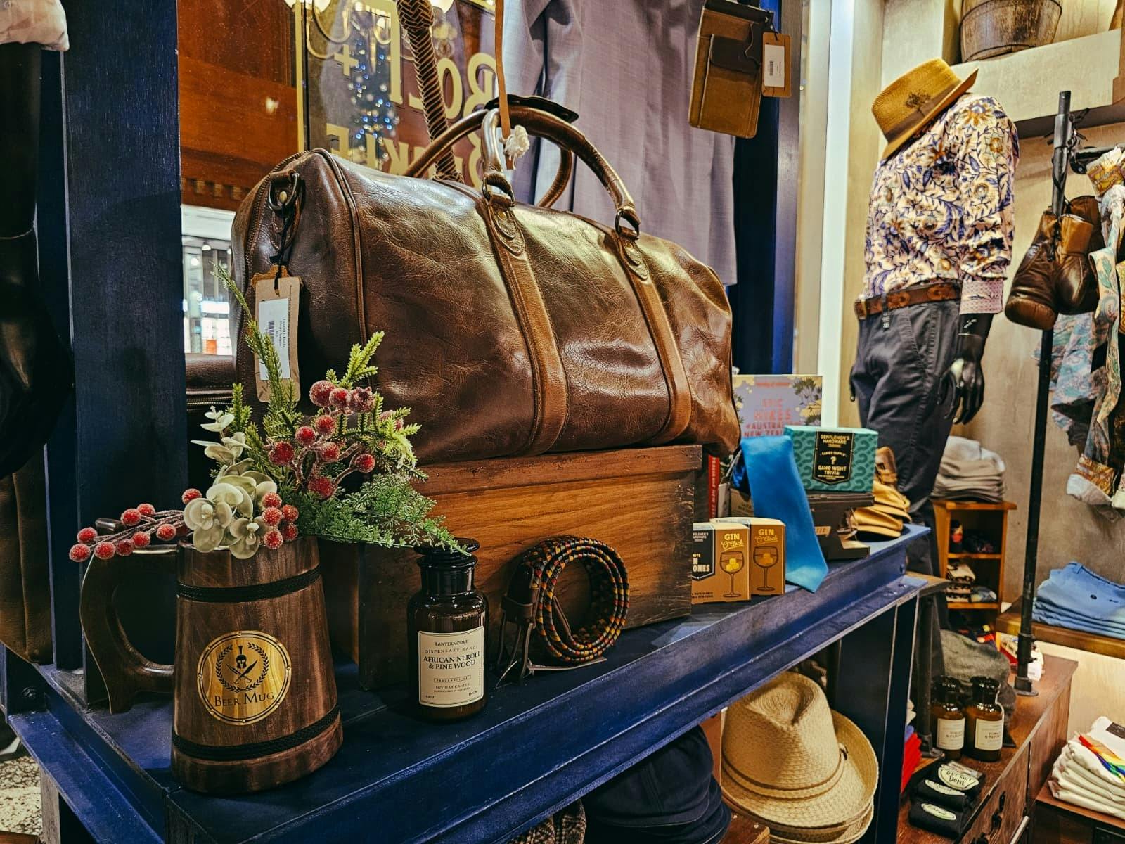 Indepal leather duffle bag with a beer mug, candle, woven belt and gin gifts