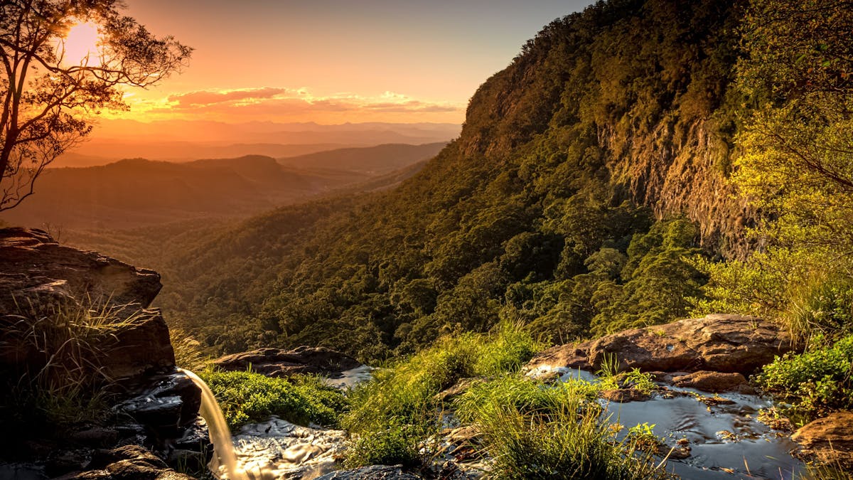 A waterfall flows into the valley below in world-heritage protected Lamington National Park A waterfall flows into the valley below in world-heritage protected Lamington National Park