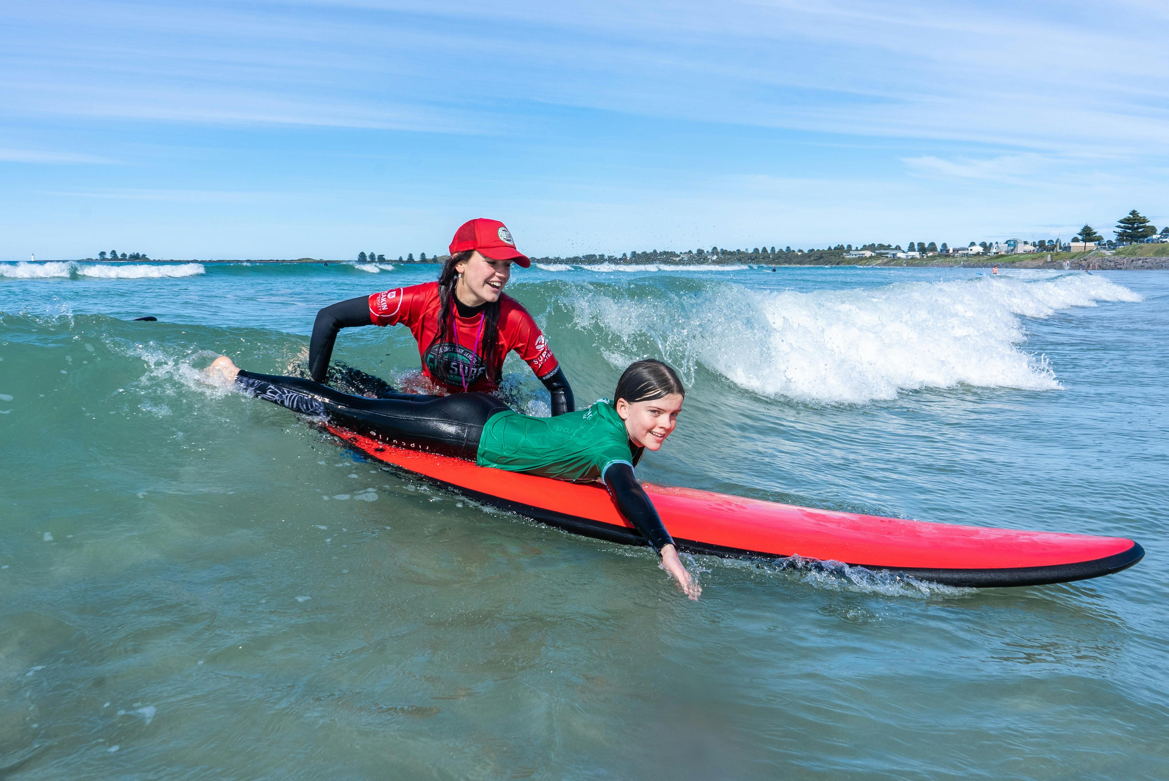 girl with surf instructor