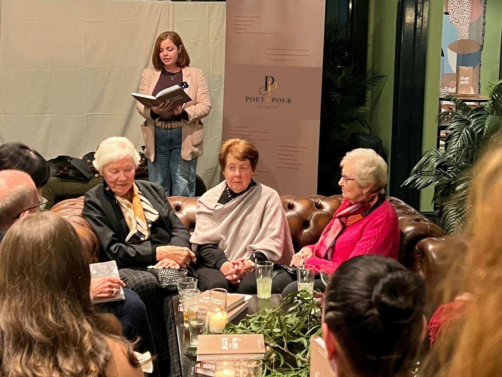 Audience listening to a poet speaking from a text