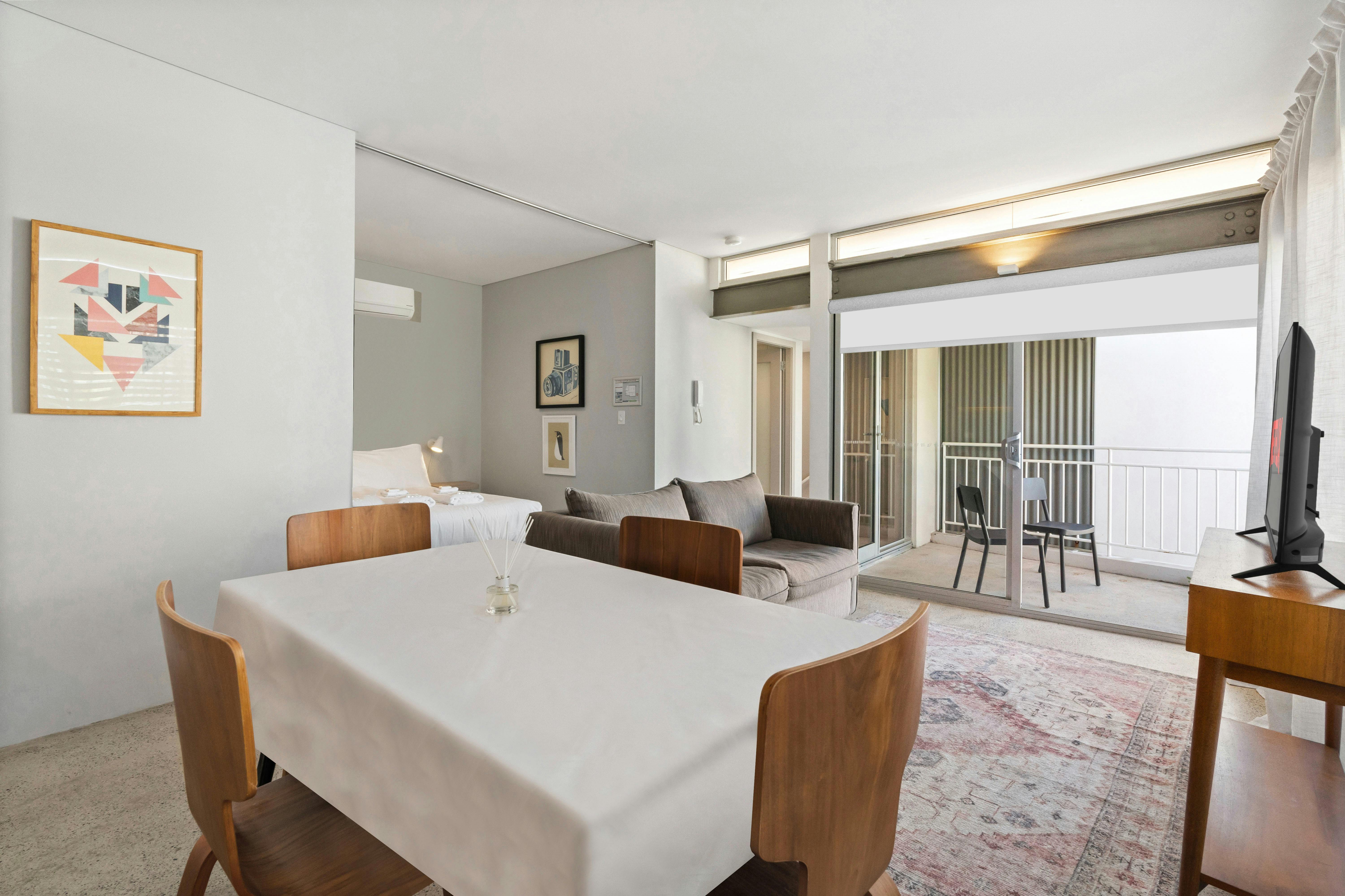 편안한 소파, TV 세련된 식사공간이 있는 아늑한 거실이 오픈 플랜으로 구성되어 있습니다.