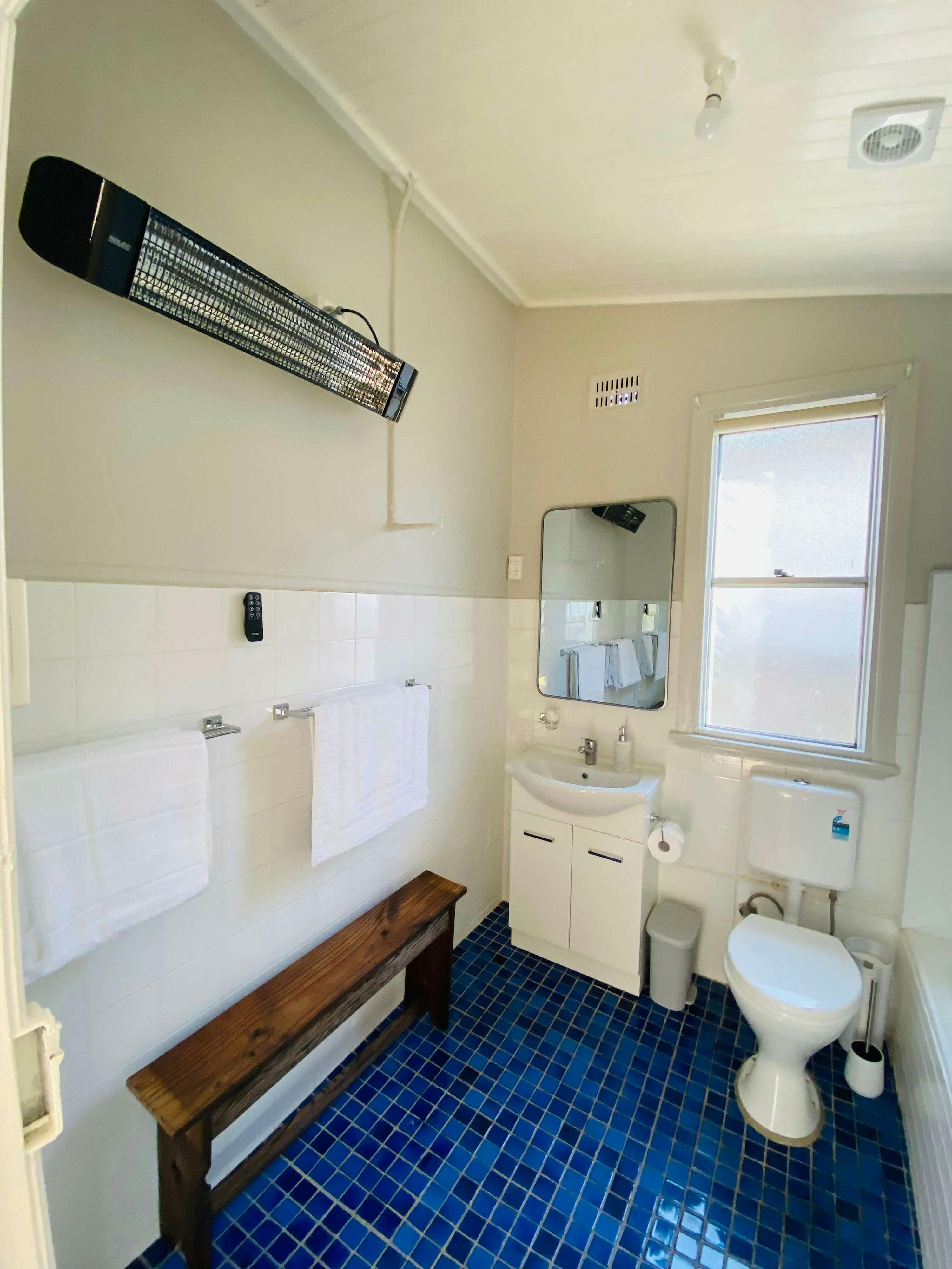 White bathroom with toilet, shower and vanity