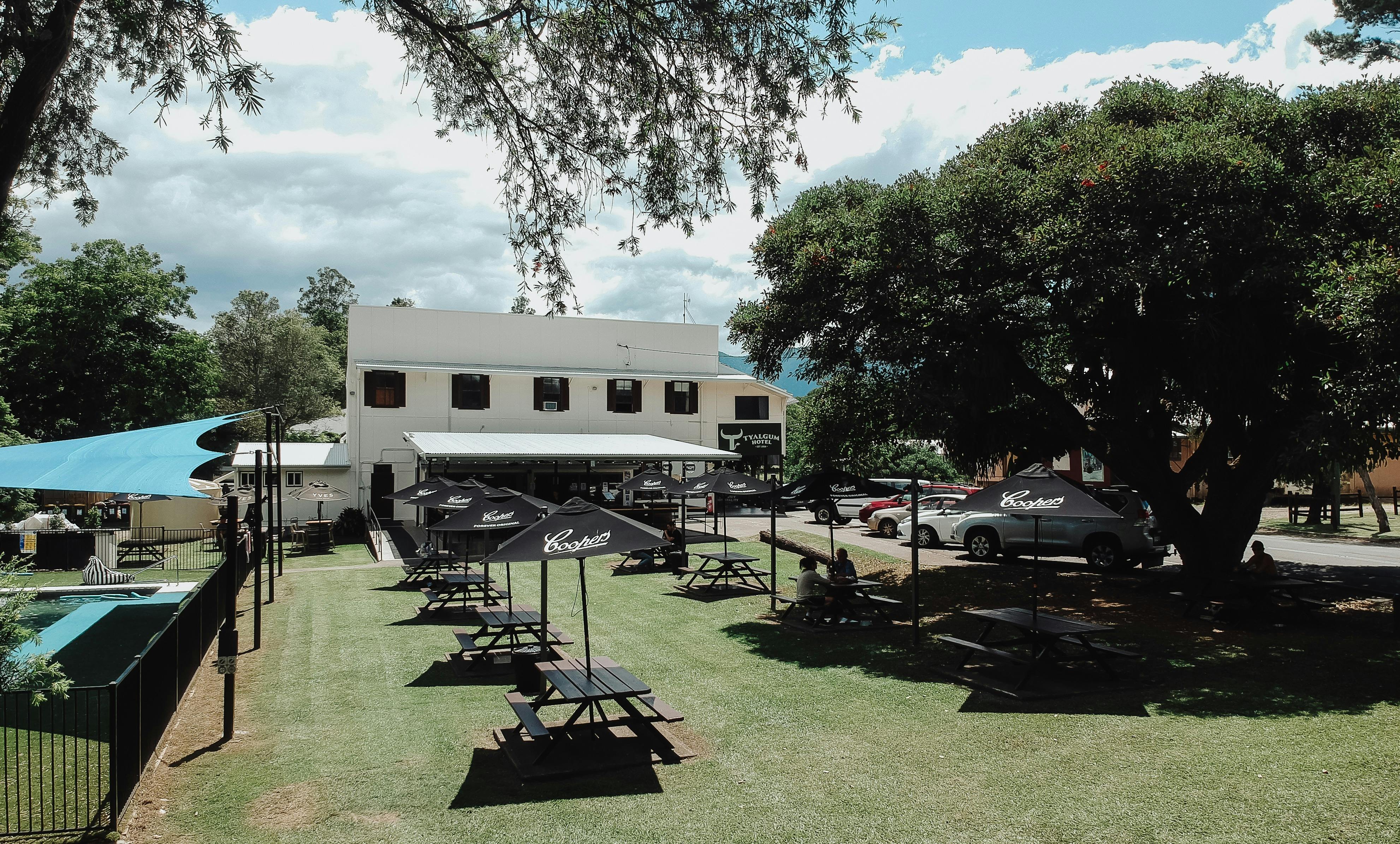 A shot looking back at the Tyalgum Hotel showing tables chairs and the corner of the pool