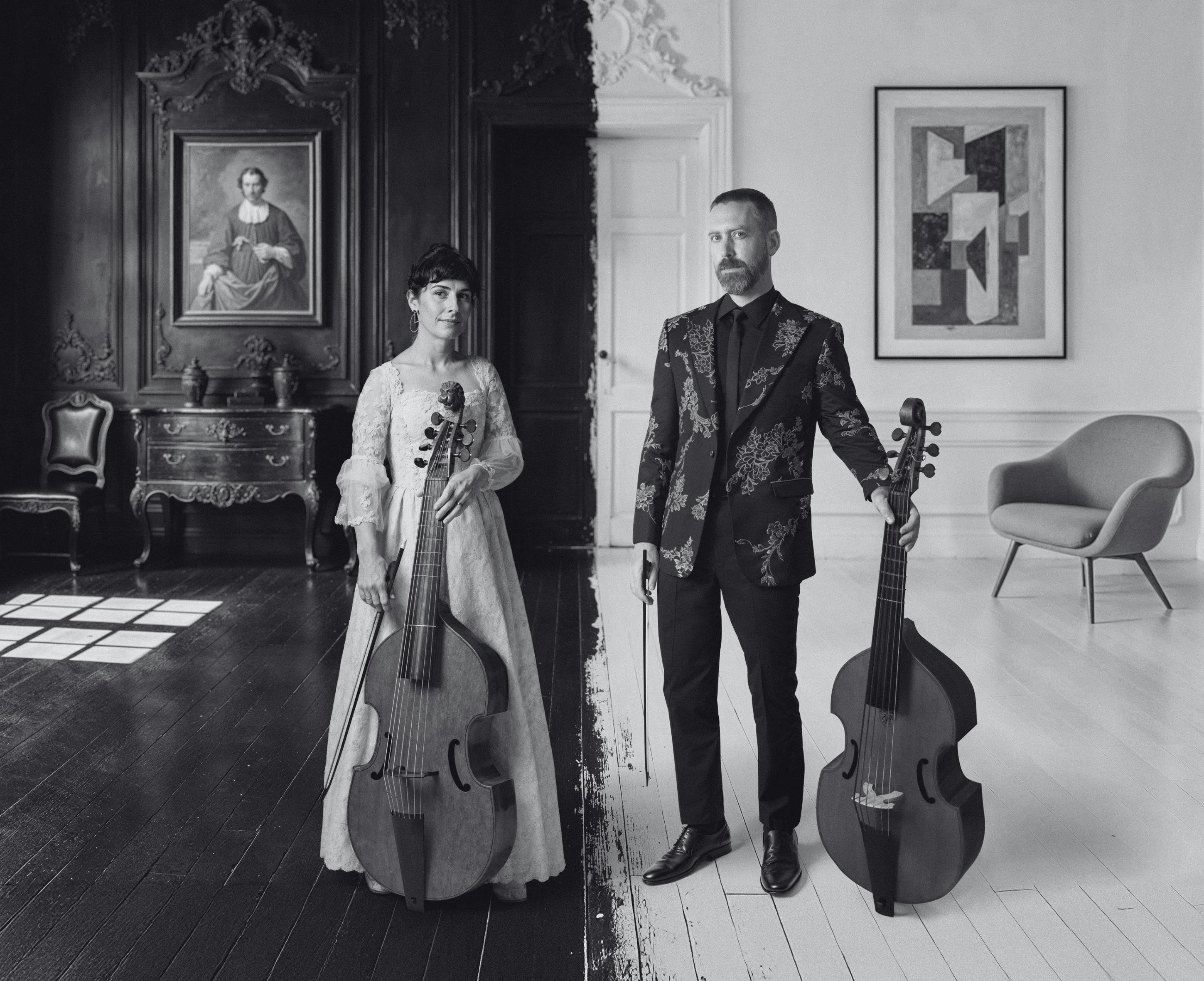Two musicians pose with their instruments