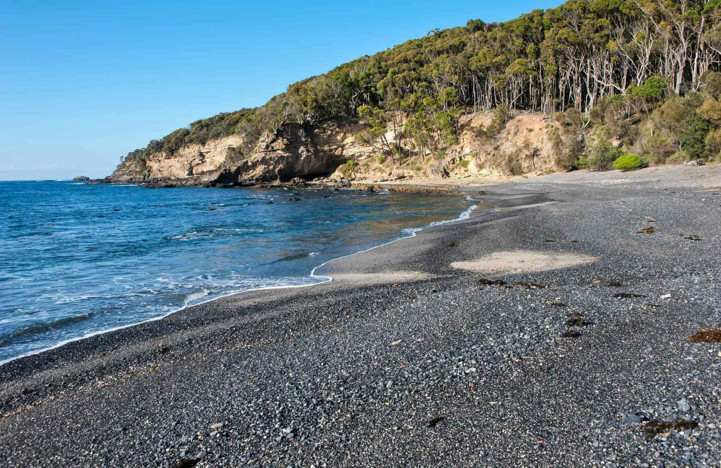 Dark beach. Secluded Beach. Unspoiled secluded Beach.