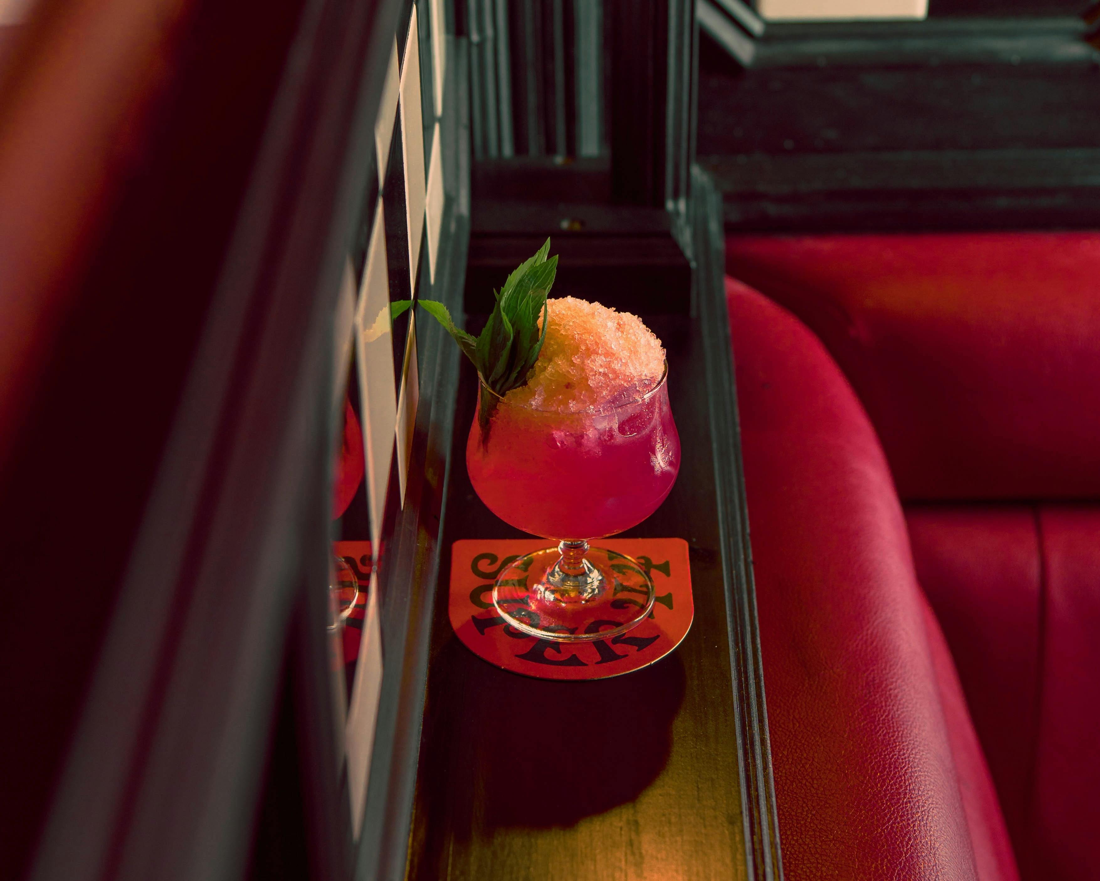 Bright pink frozen margarita with hand-shaved ice and fresh mint.