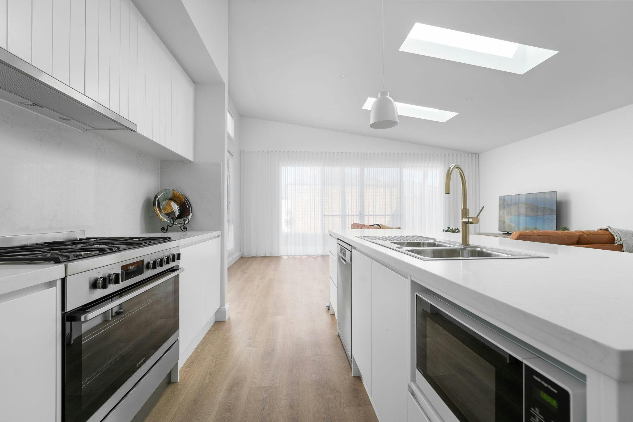 Large white modern kitchen with all the appliances and modern fixtures