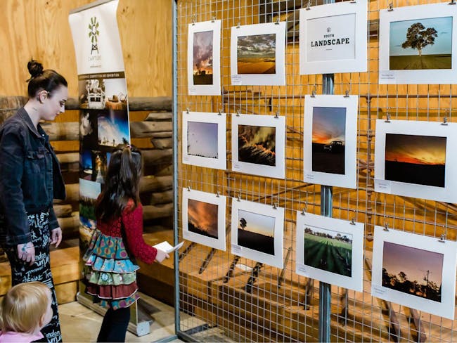 A young family viewing Youth Landscape displays