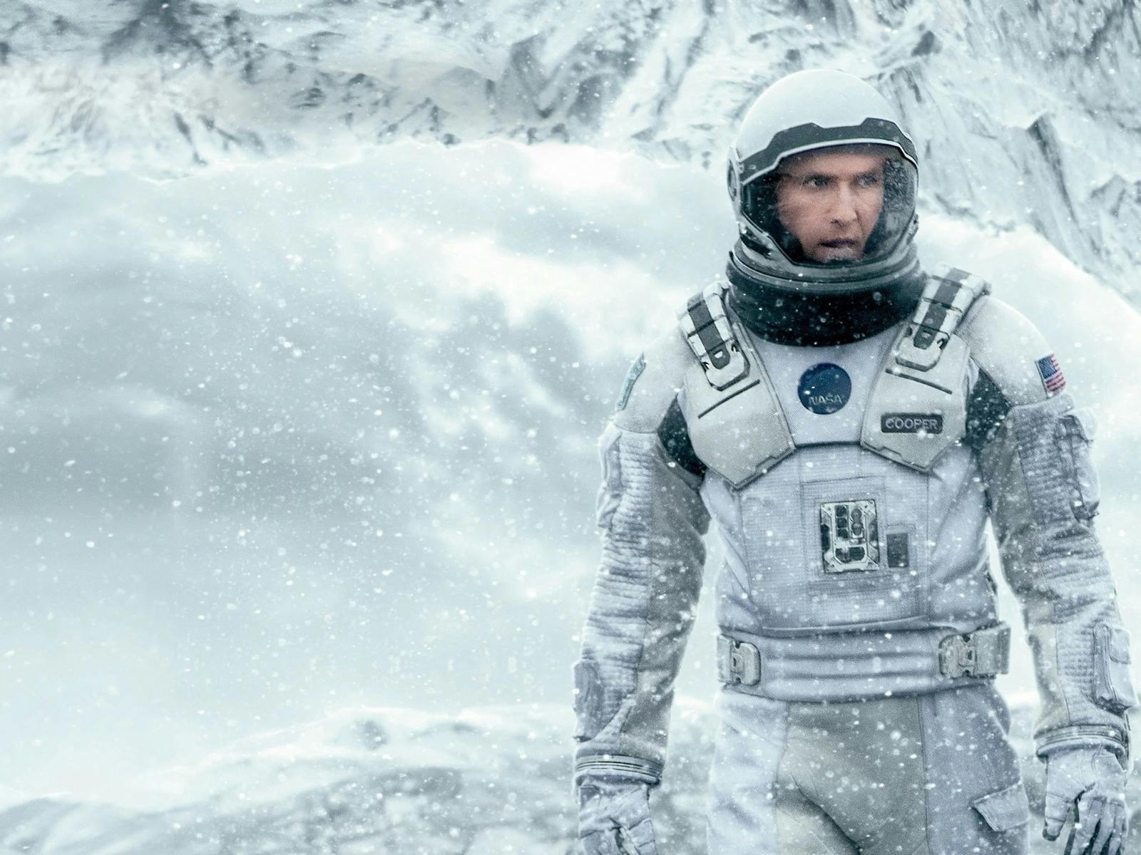 Man wearing a space suit in snow surroundings
