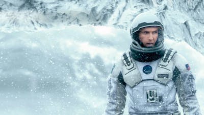 Man wearing a space suit in snow surroundings