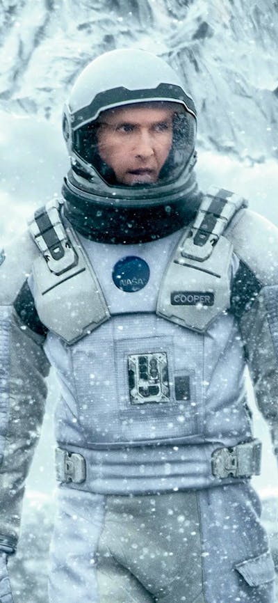 Man wearing a space suit in snow surroundings