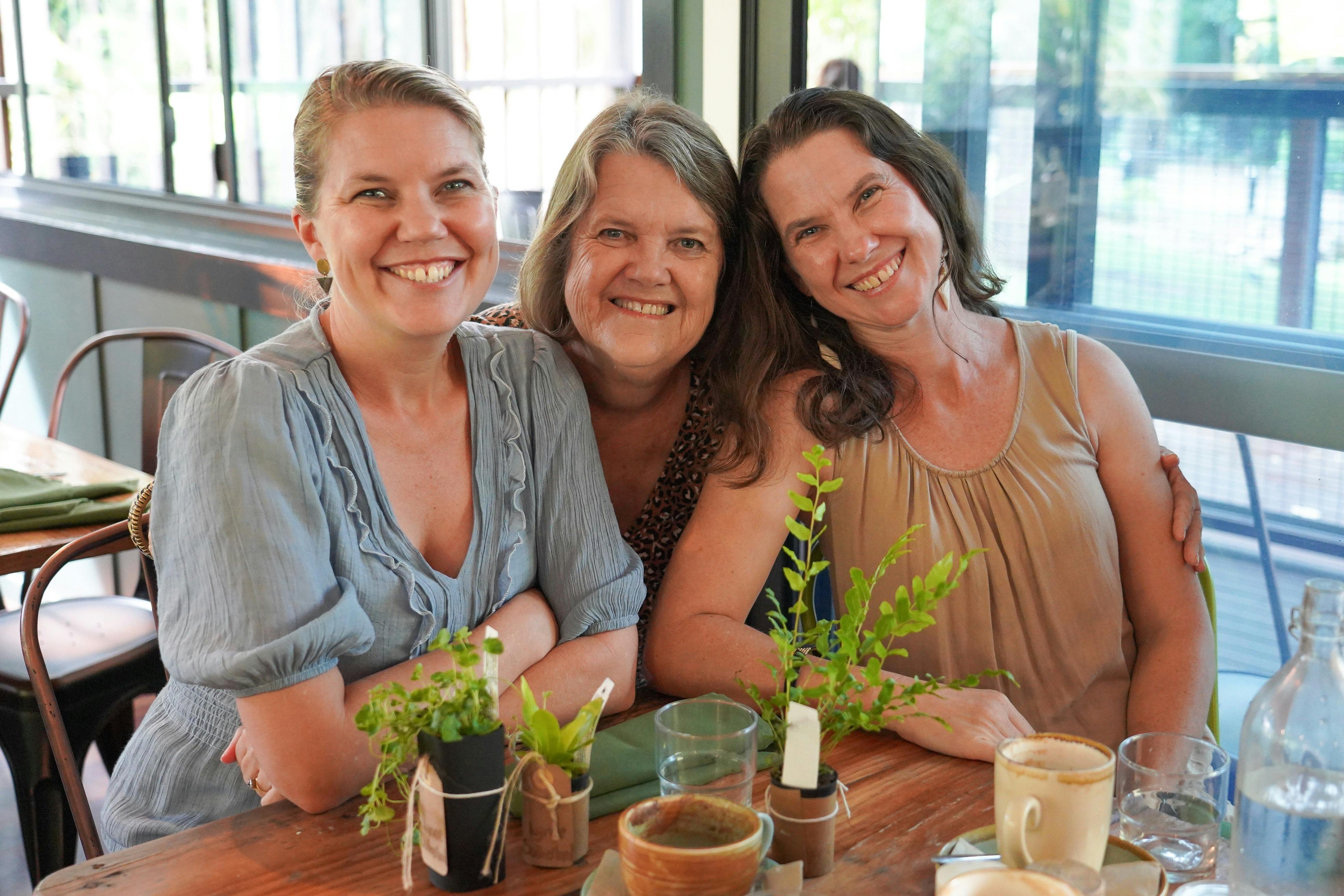 Mother and daughers at breakfast inside cafe for event