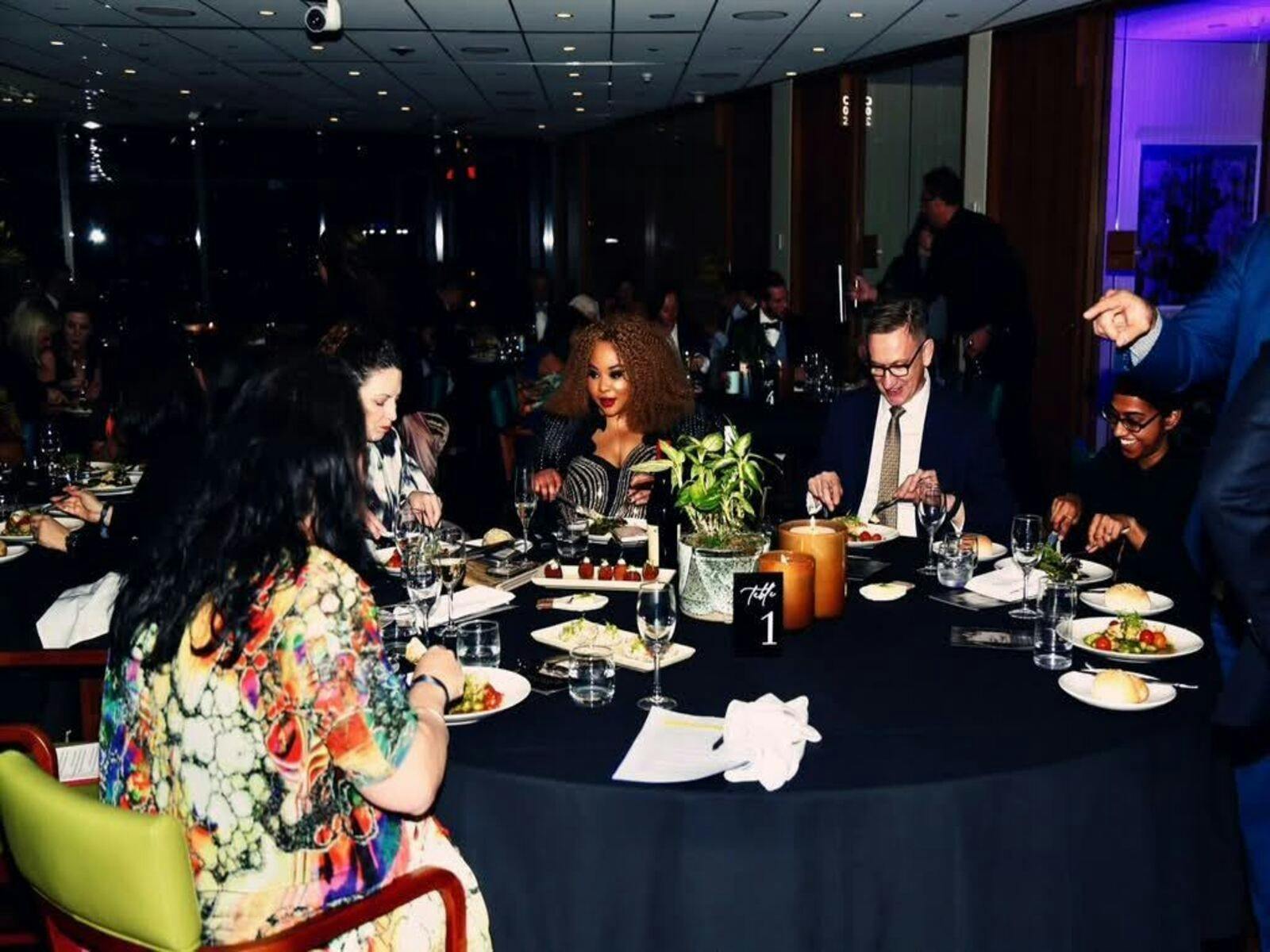 Professionals from diverse backgrounds at a formal gala dinner event.