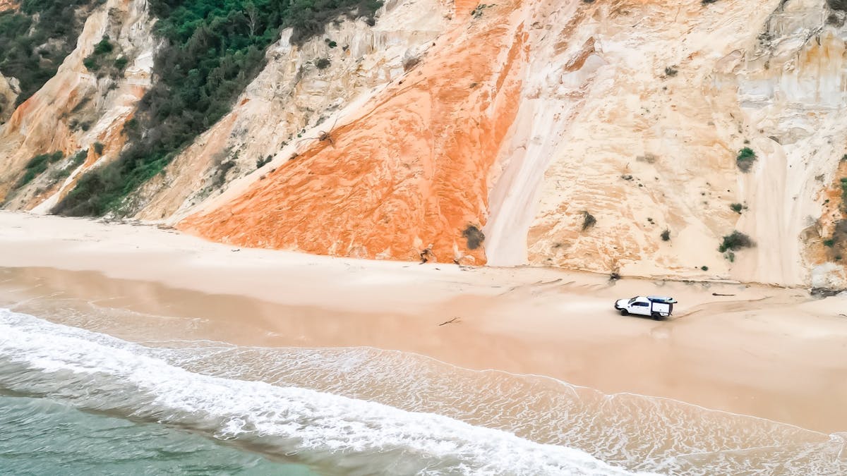 4WD driving along the stunning coloured sands of Rainbow Beach