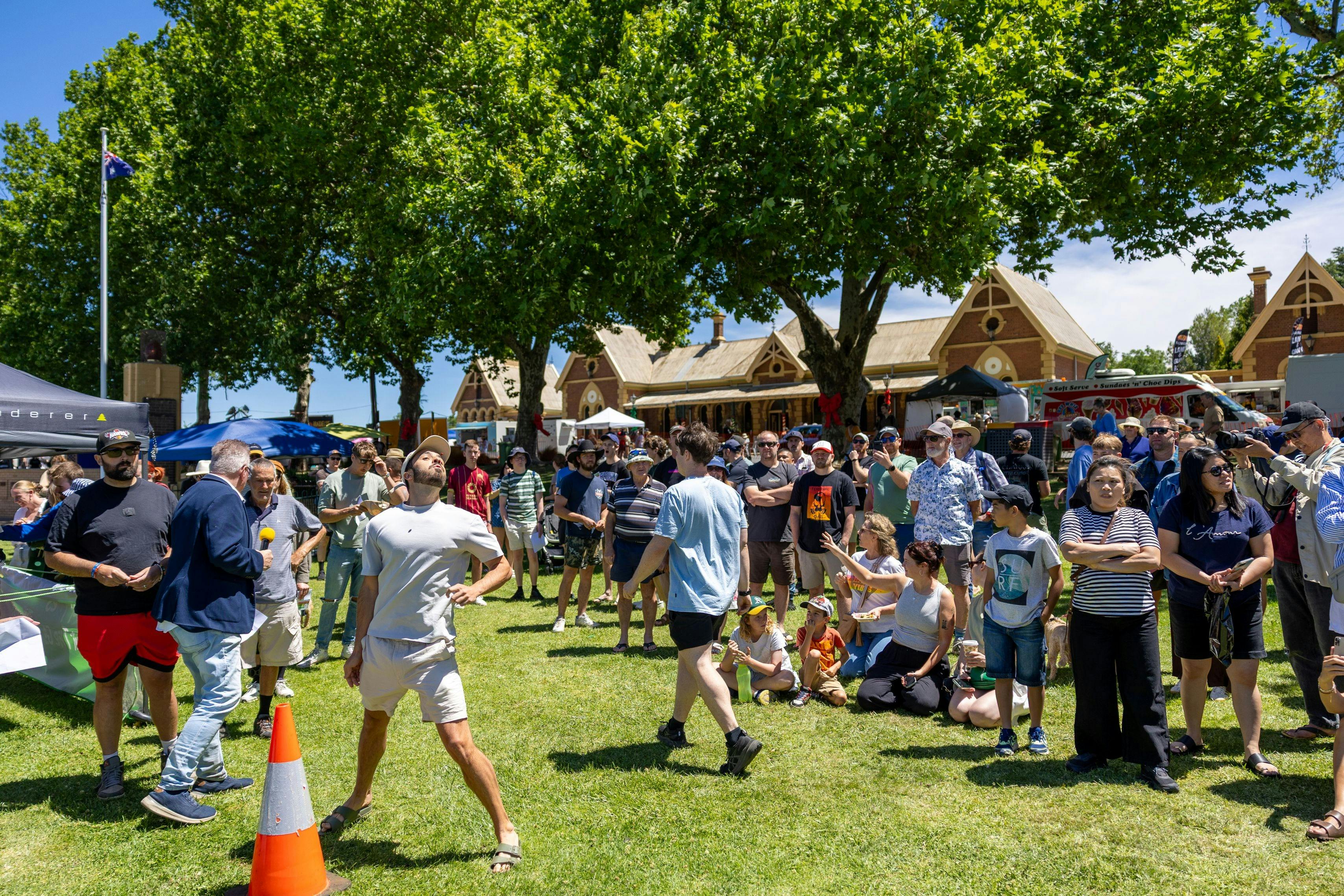 Cherry pip spit competition with a crowded gathered to watch contestants.