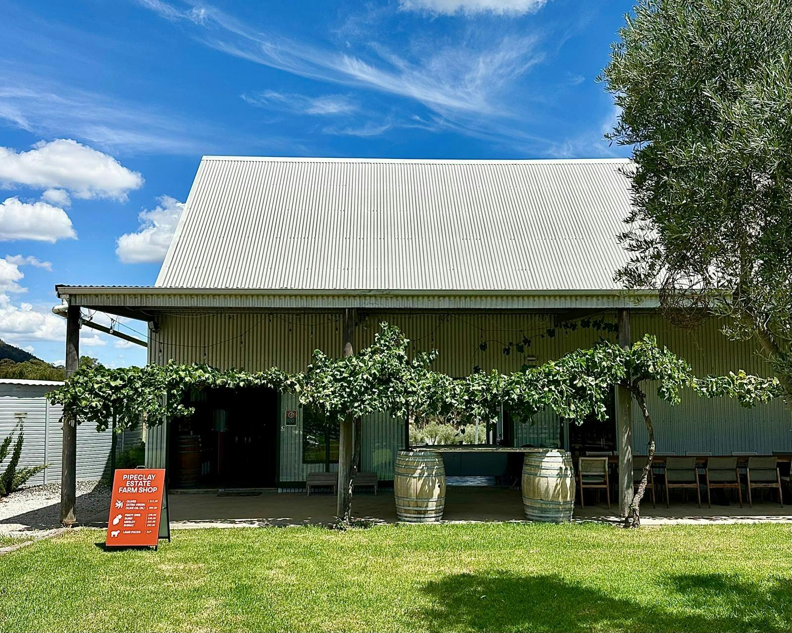 Shed style cellar door, featuring burnt orange sign out the front.