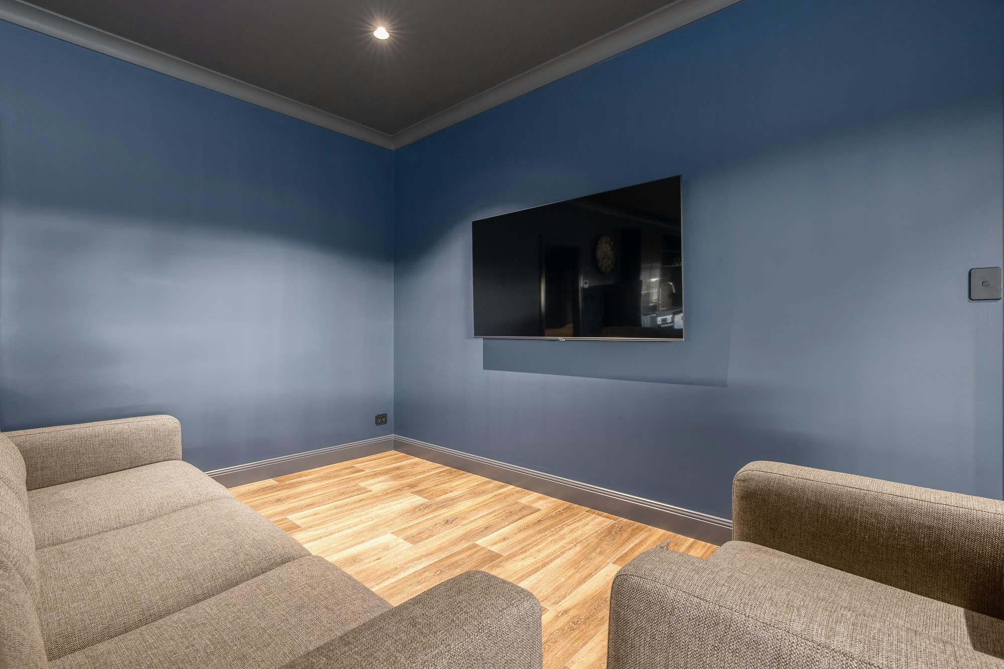 Small lounge area with 4 seater lounge and large tv