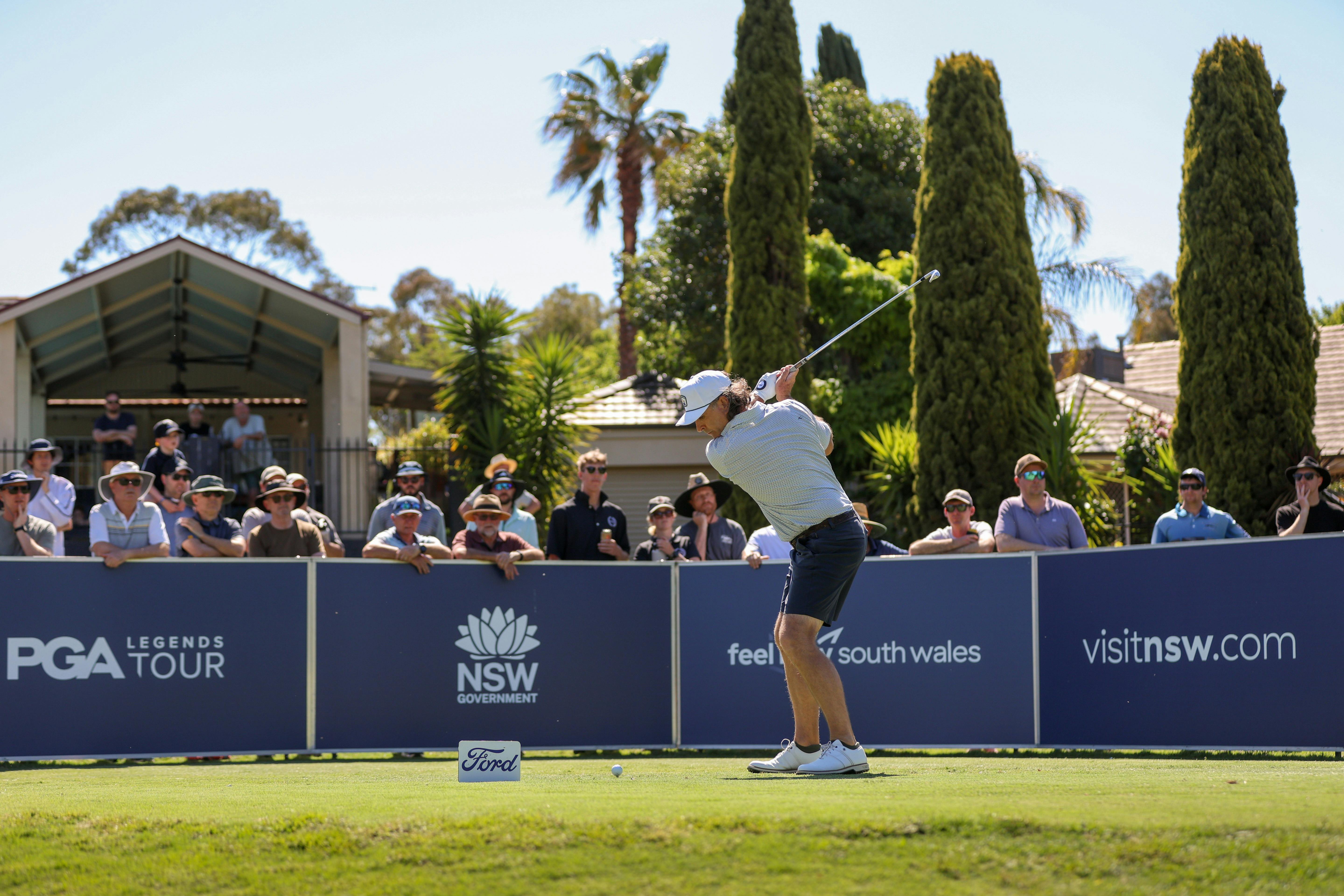 Golfer teeing off
