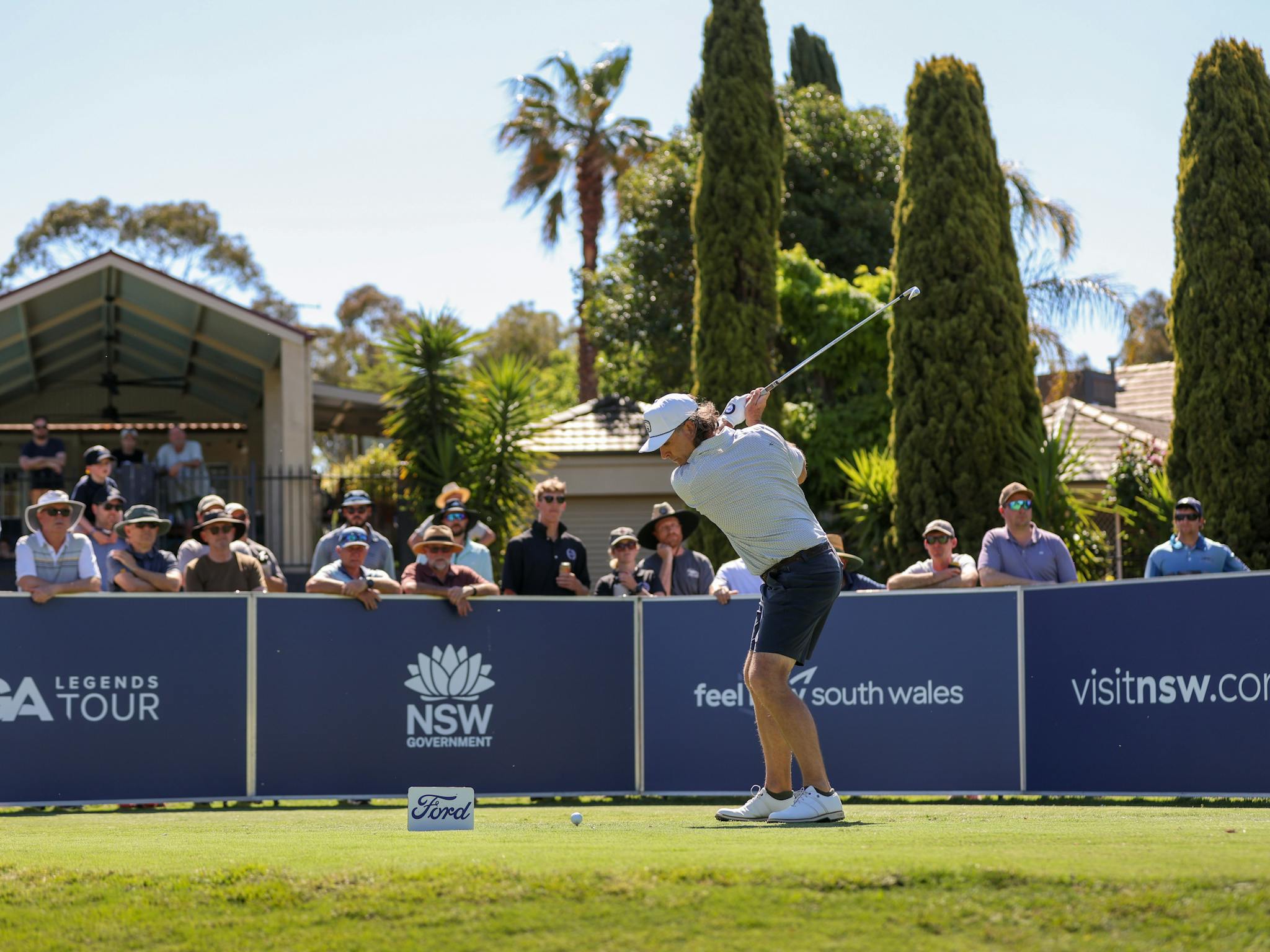 Golfer teeing off