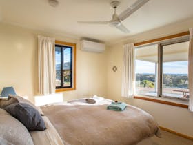 Queen bed with sea views, ceiling fan and split system