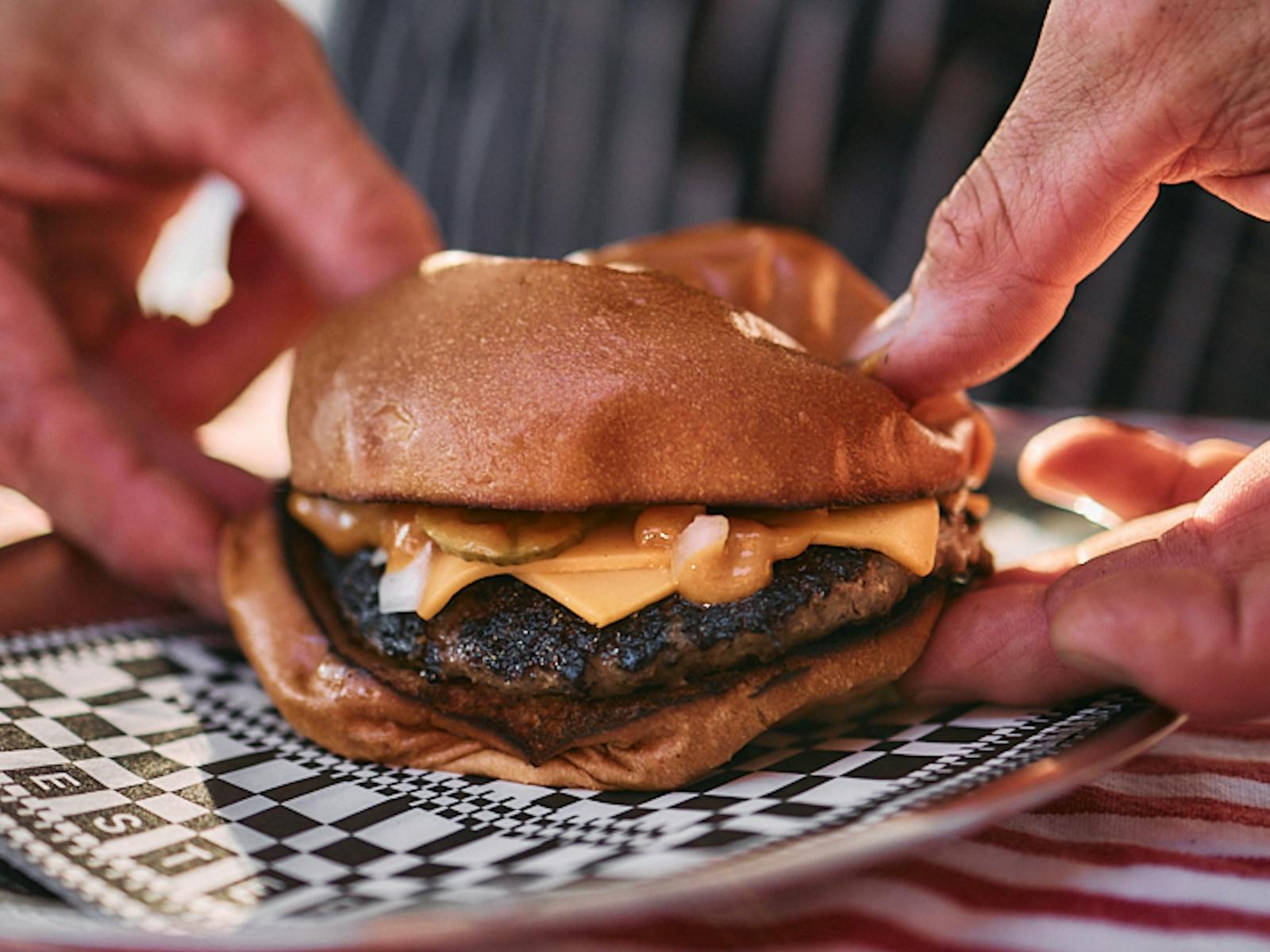 Hands holding a burger