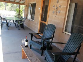 Private verandah with a gas BBQ, outdoor dining and recliner chairs