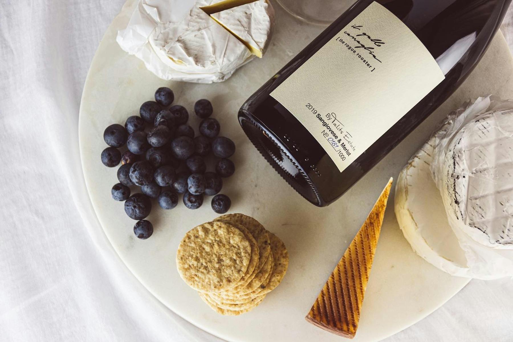 A plate serving cheses, berries and local Hunter Valley Wine