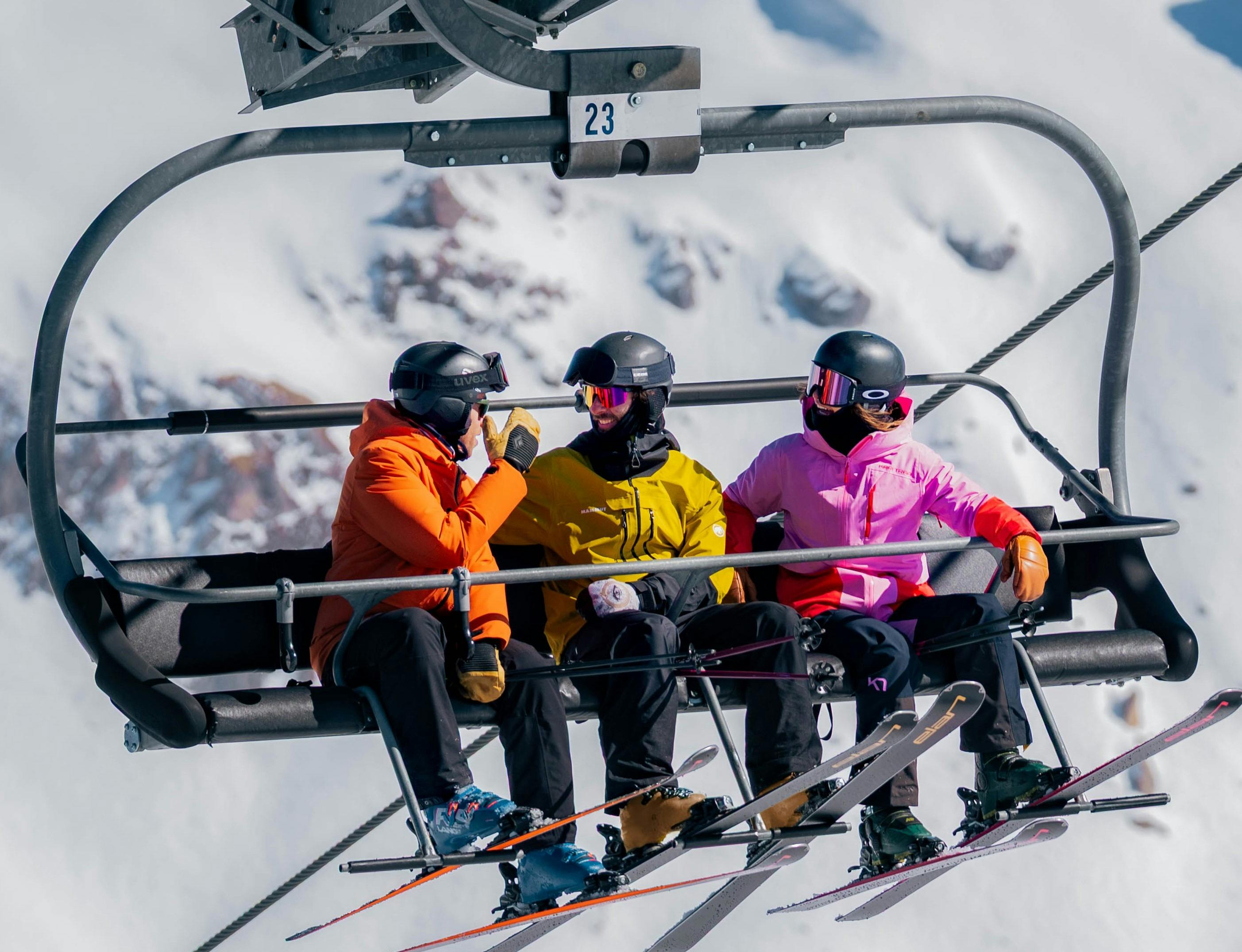 3  skiers riding the chairlift