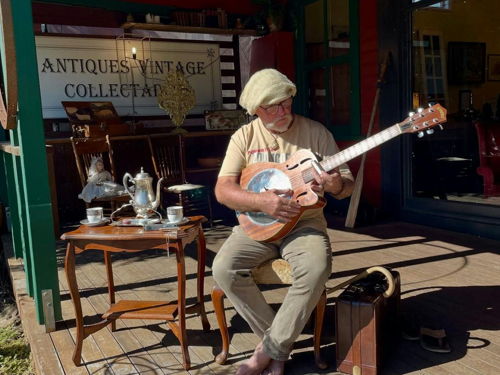 Man playing guitar on verandah