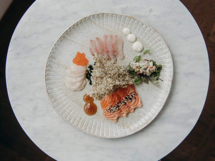 A bird's eye view of a brightly coloured sashimi platter