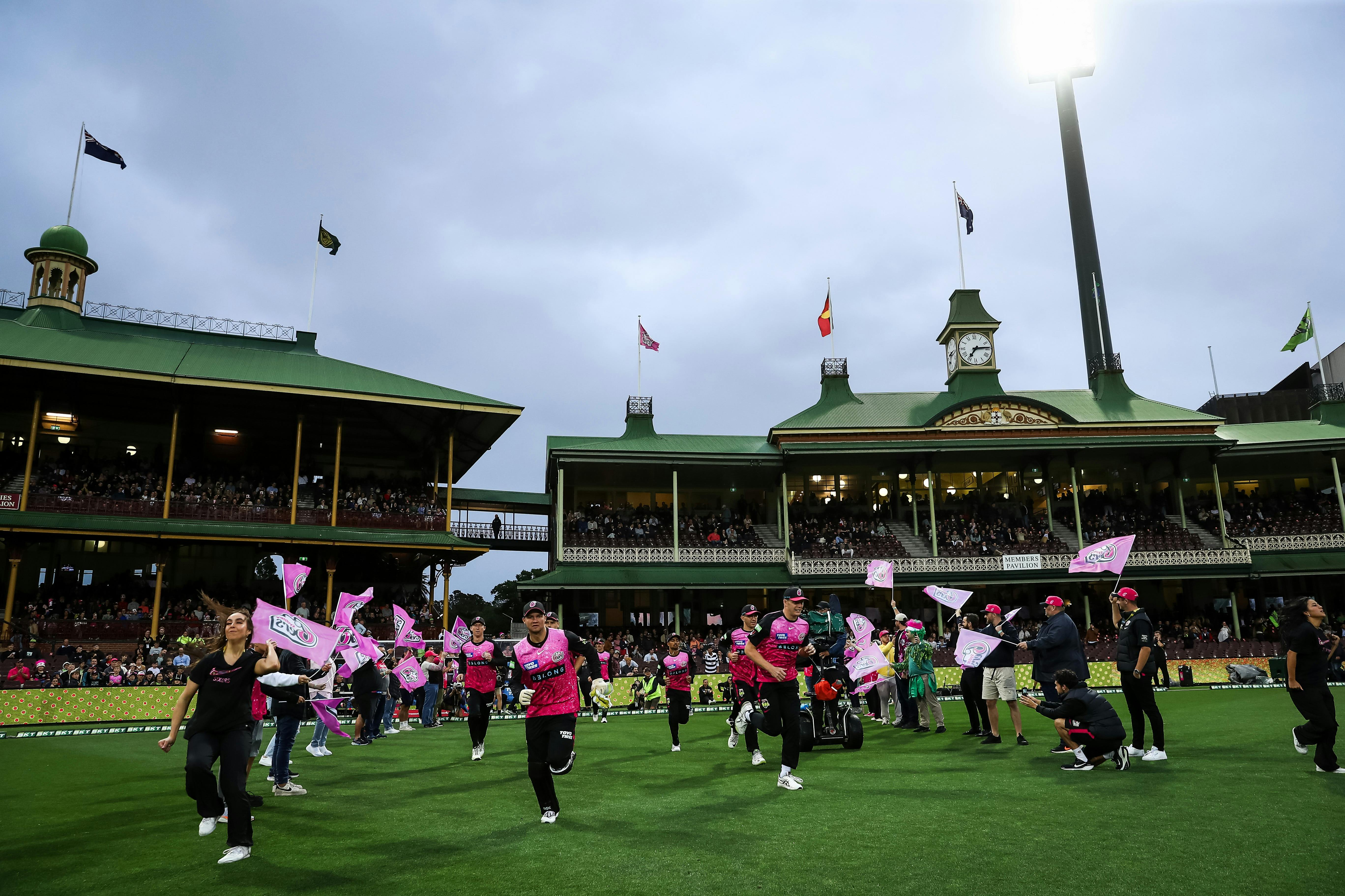 Sixers players run out at the SCG.