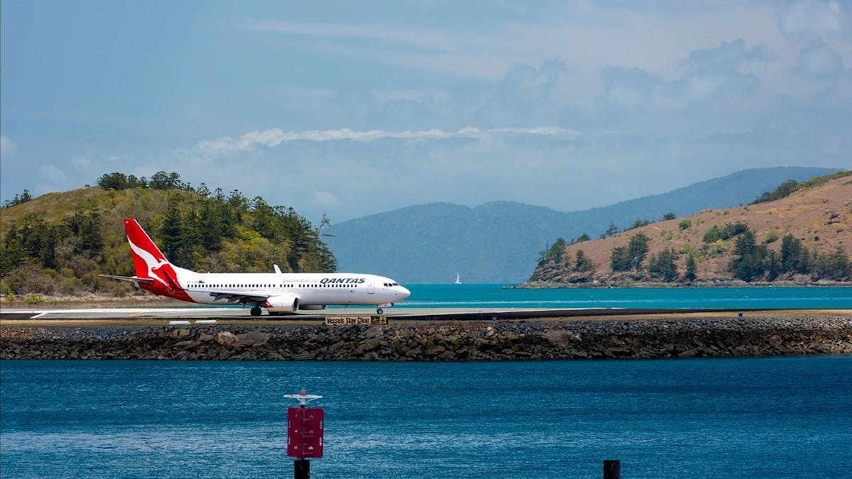 Aircraft on the island's airstrip surrounded by water and hilly islands