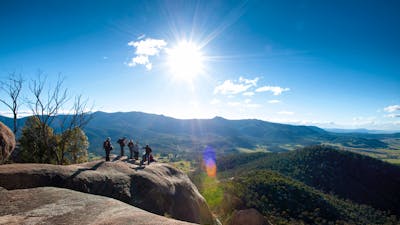Small group of people looking out over magnificent views of the valley and mountain ranges