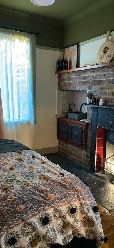 Massage room with subtle light and historical features including fireplace .