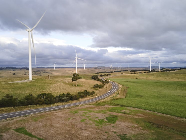 landscape shot of wind farm with numerous turbines off in distance