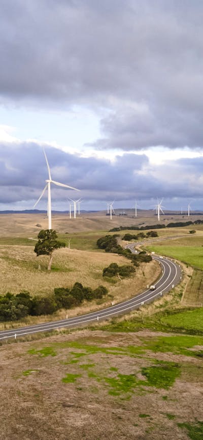 landscape shot of wind farm with numerous turbines off in distance