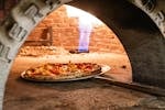 Pizza coming out of the woodfired pizza oven at Rules Club Wagga