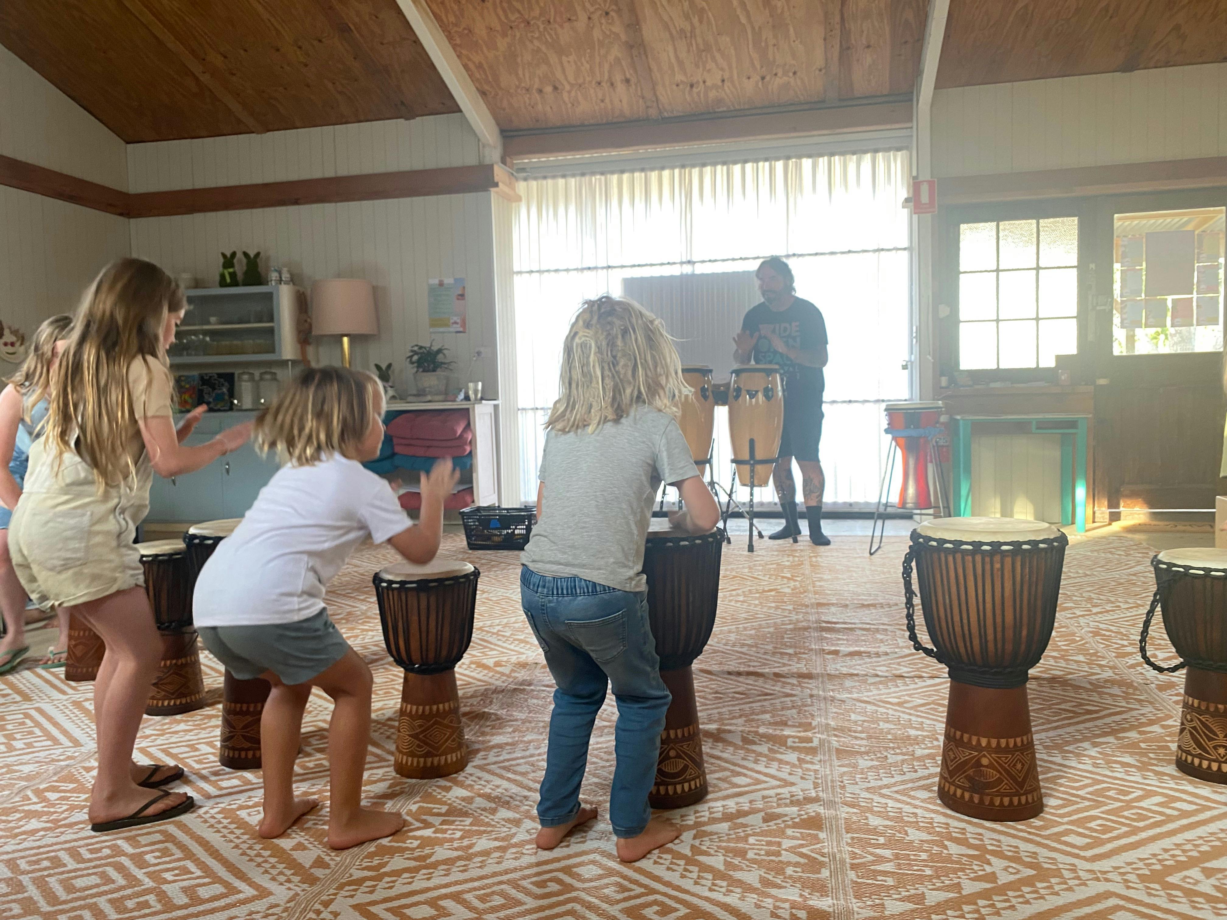 Children drumming on djembe drums