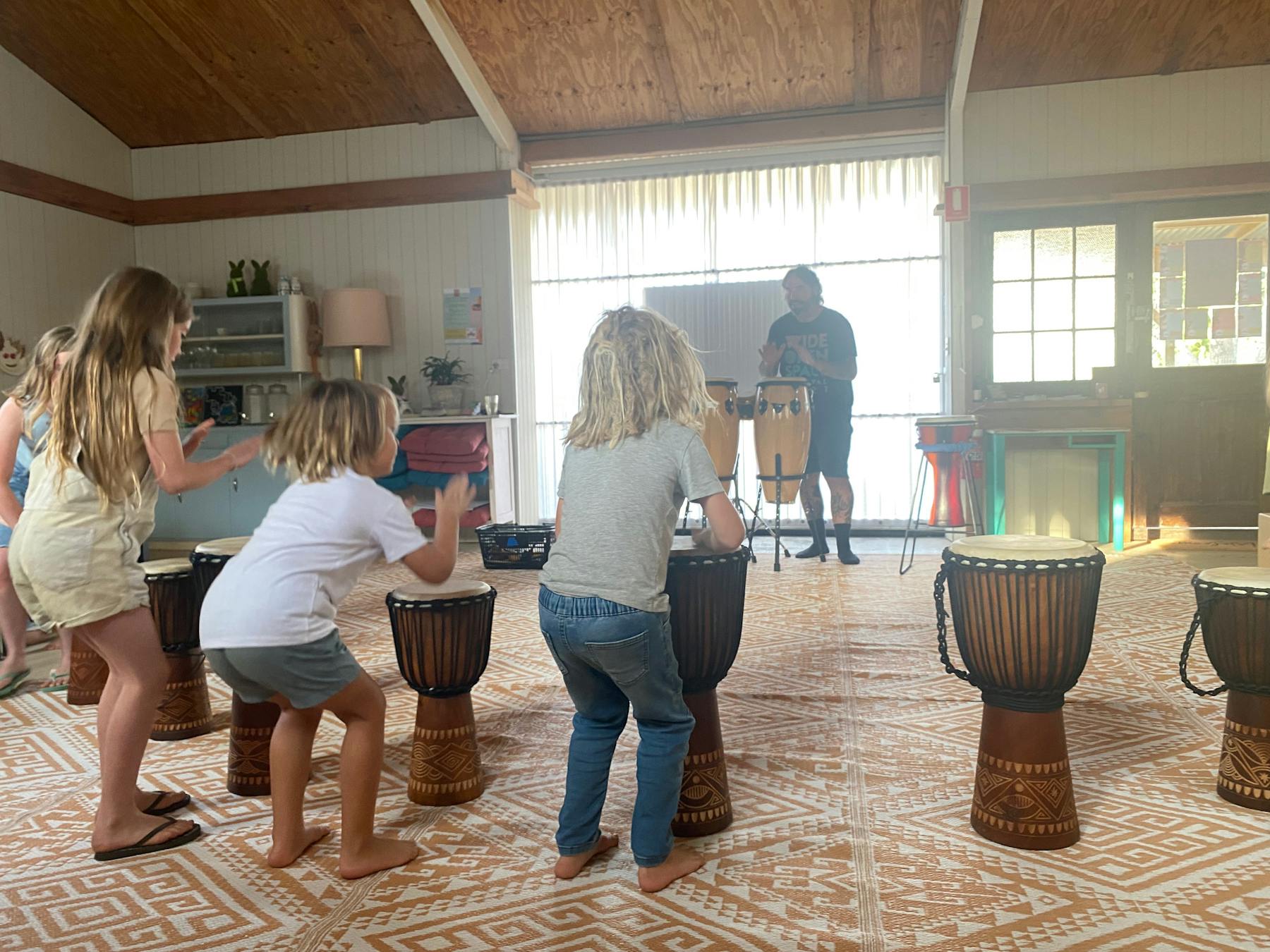 Children drumming on djembe drums