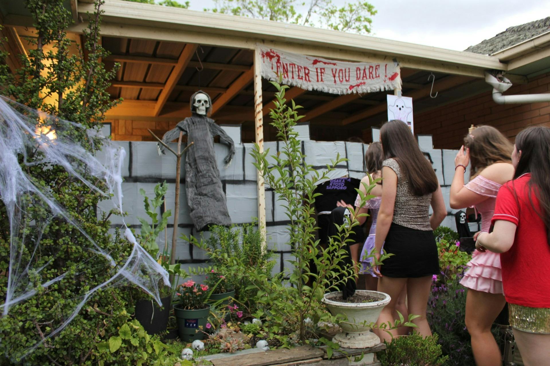 Trick-or-Treaters entering decorated house