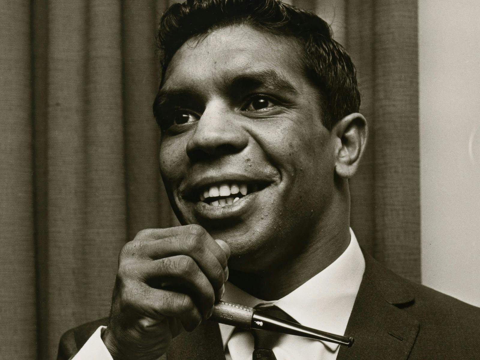 Smiling man in white shirt and tie, black and white photo