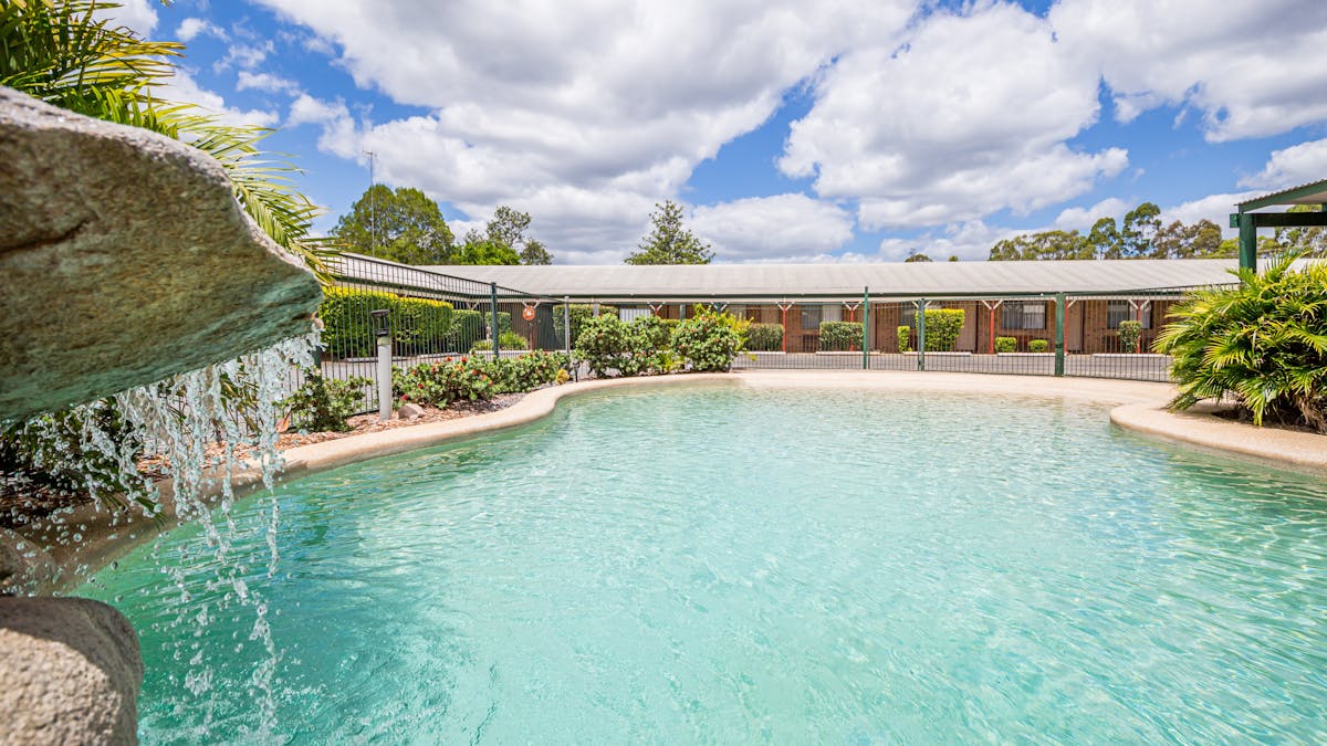 Walk-in salt water swimming pool with pergola & pool towels. Shallow end for kids, water fall & seat