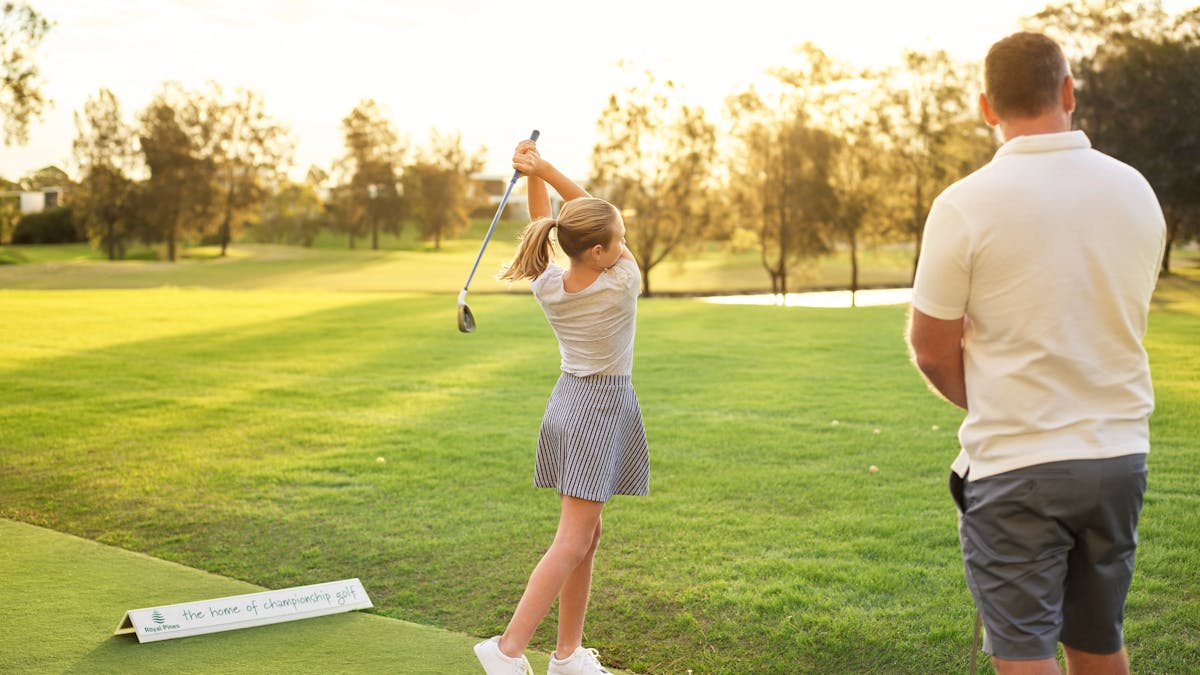 Father and daughter playing golf