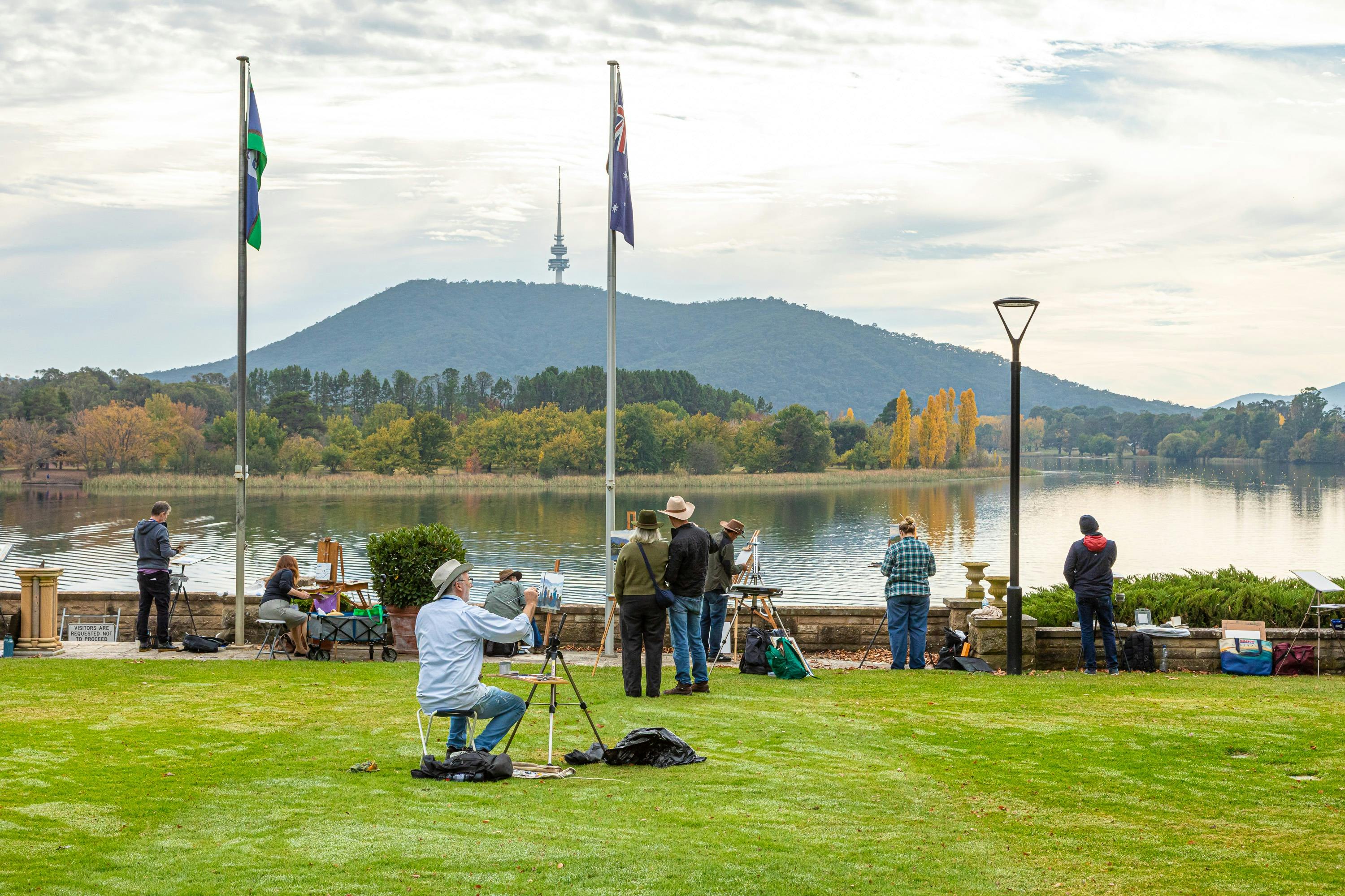 Artists painting on the lawn of Government House overlooking Lake Burley Griffin