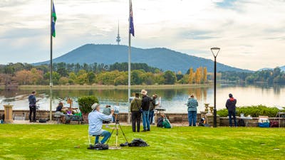 Artists painting on the lawn of Government House overlooking Lake Burley Griffin