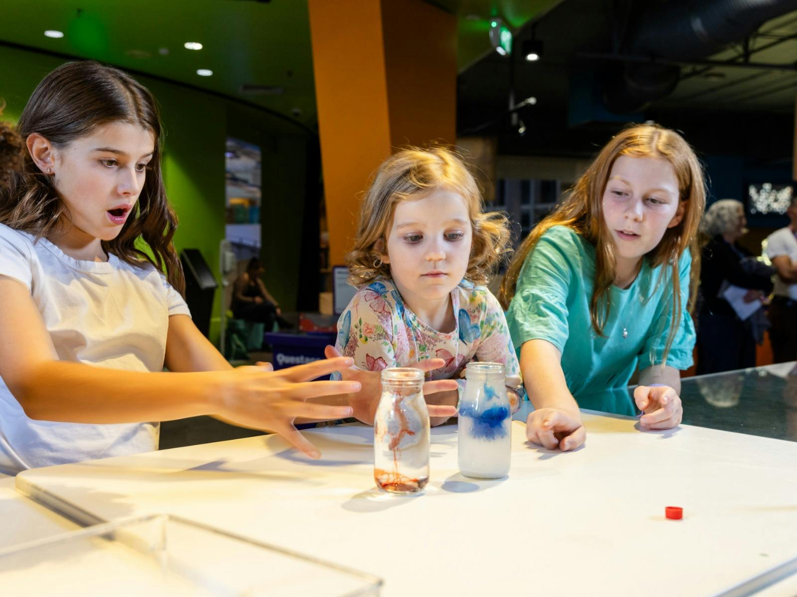 Children participating in a live science demonstration at Questacon
