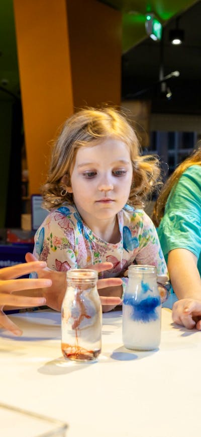 Children participating in a live science demonstration at Questacon