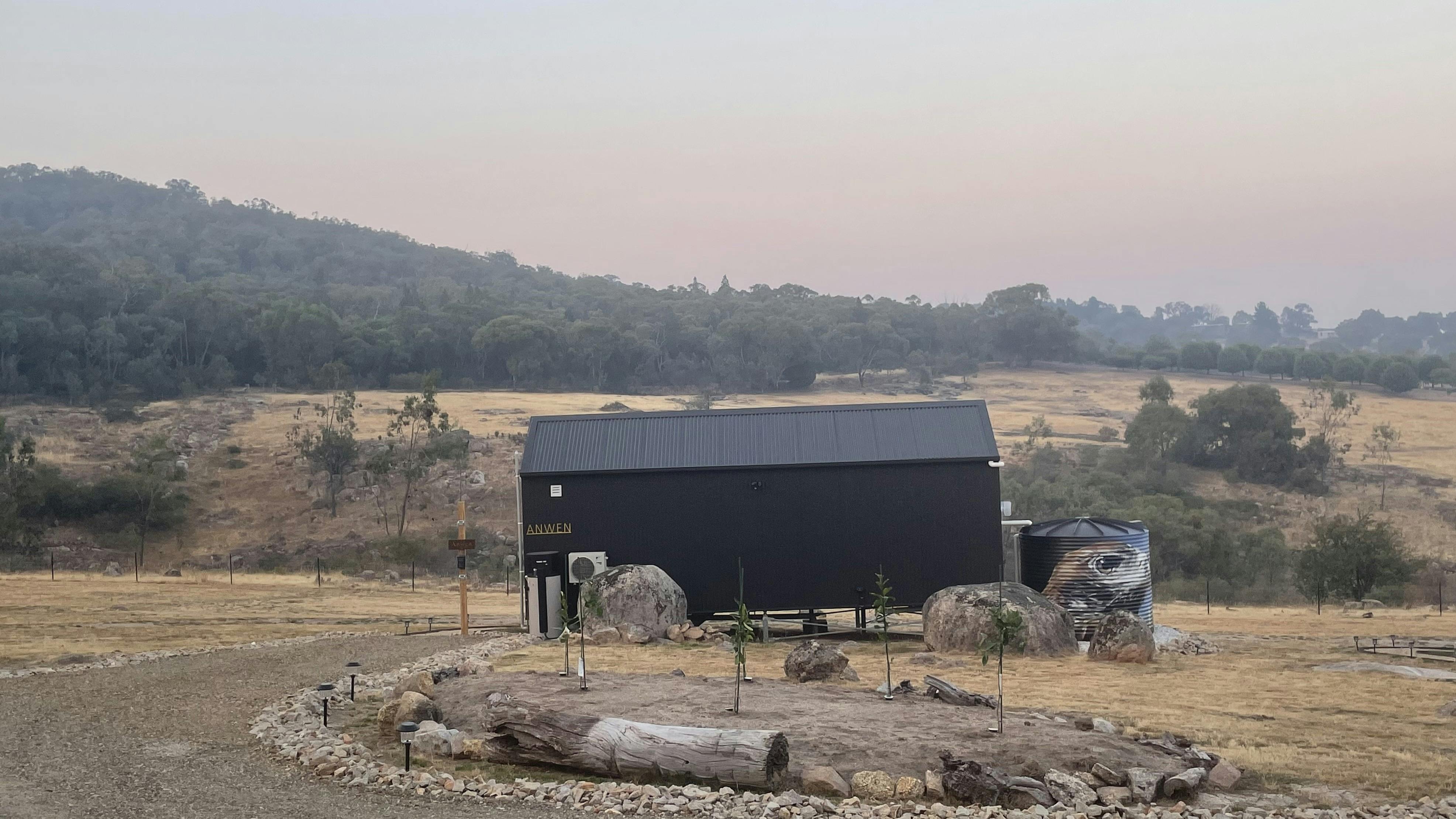 A single tiny home set within open countryside.
