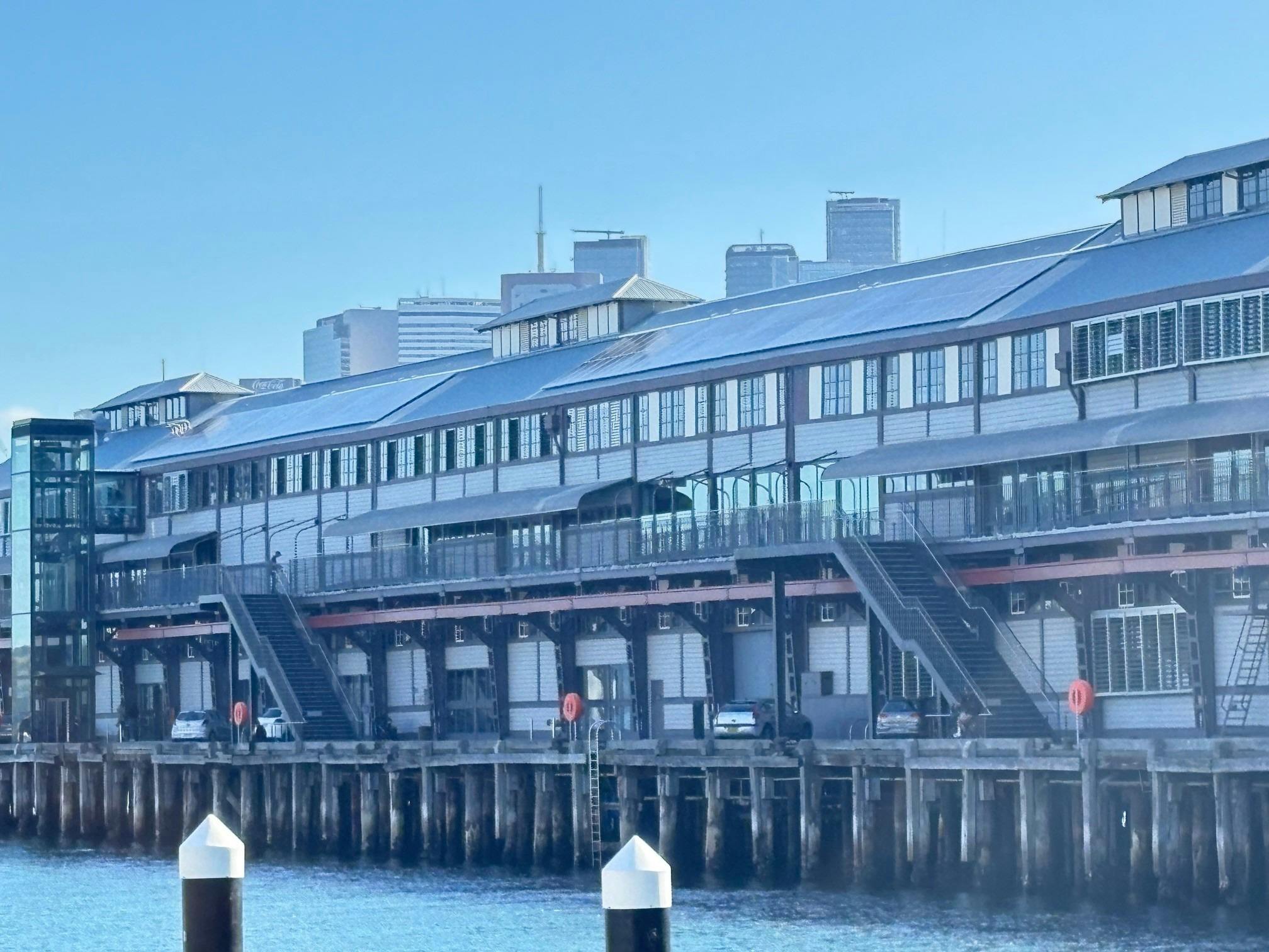 Imposing wharf with blue water in the foreground