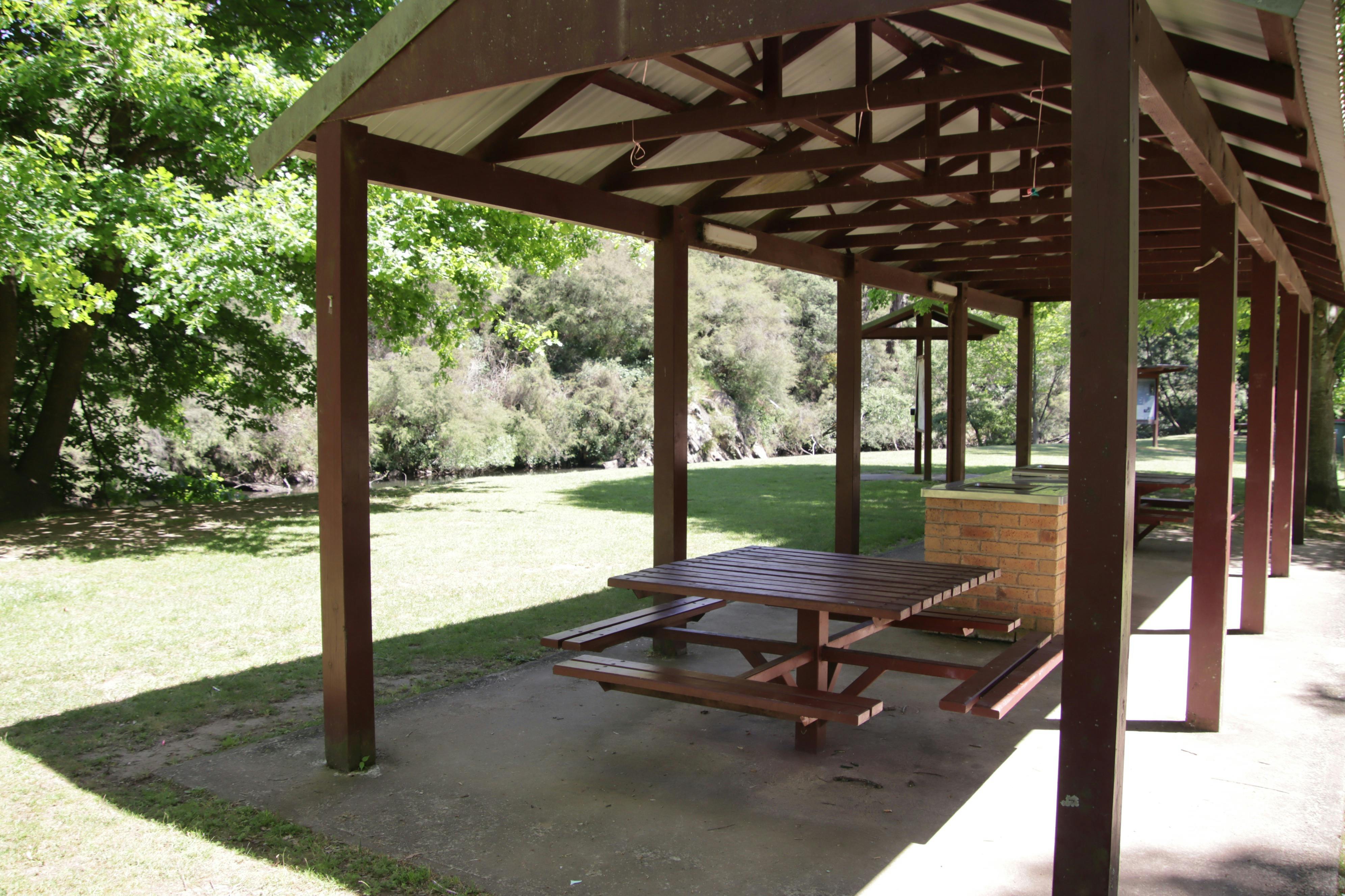 Shelter with bbq and seats by river